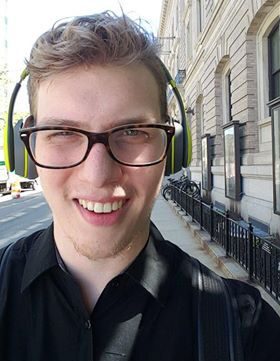 Close-up of a cheerful man on sidewalk