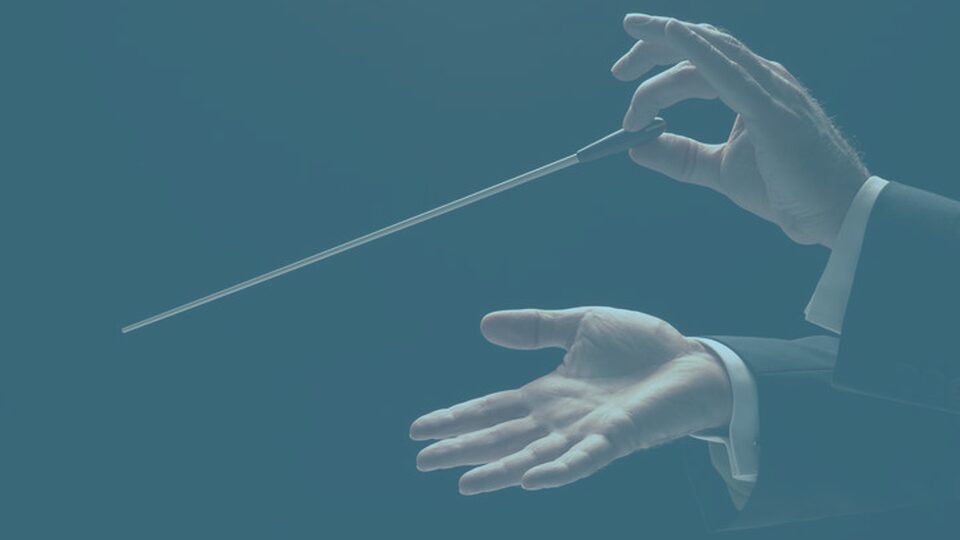 A gloved hand holding a long medical swab stick.